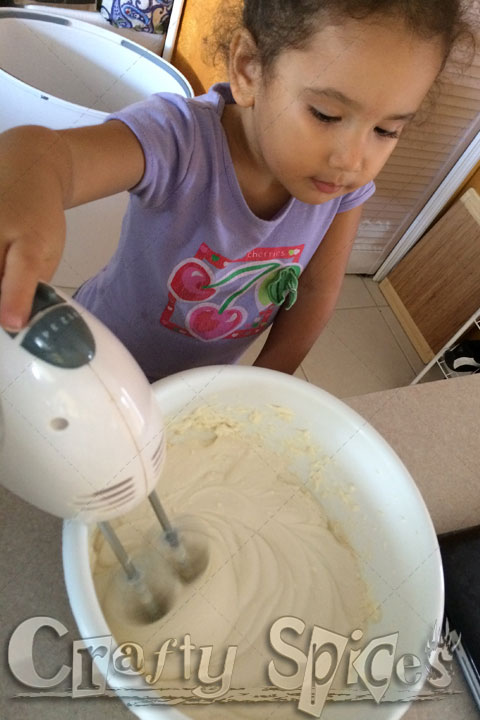 Our little girl having fun and learning in the Kitchen