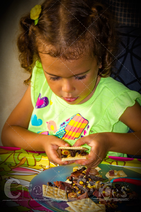 Kira enjoying her cocktail, making cracker sandwiches