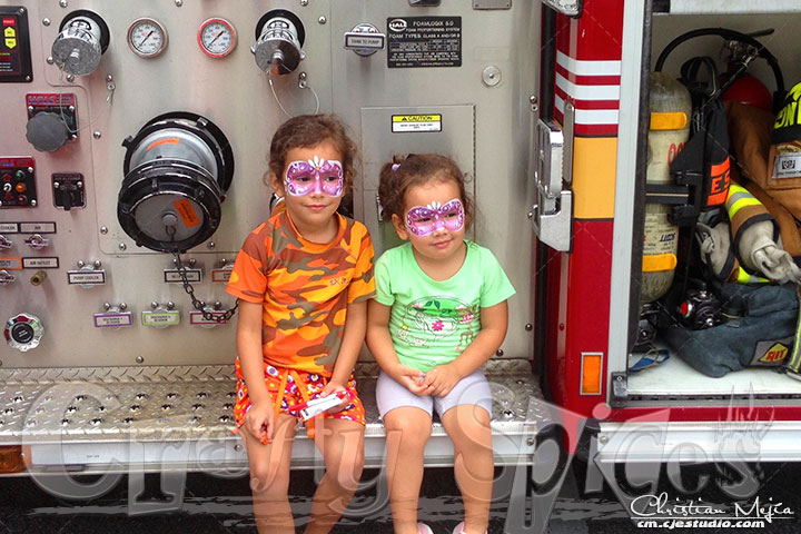 Kira & Kaylee sitting on a FireFighter truk