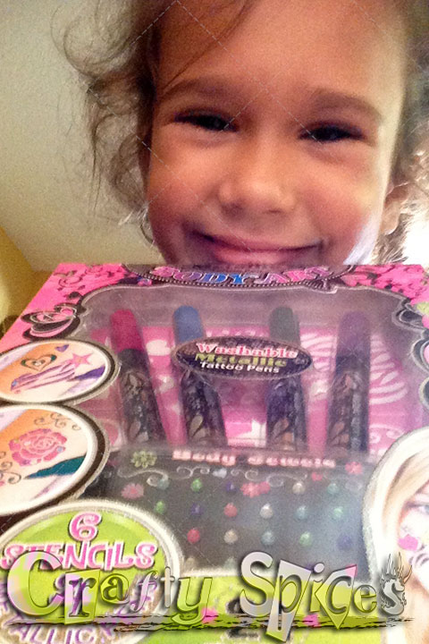 Kira's happy face with the new tattoo play set